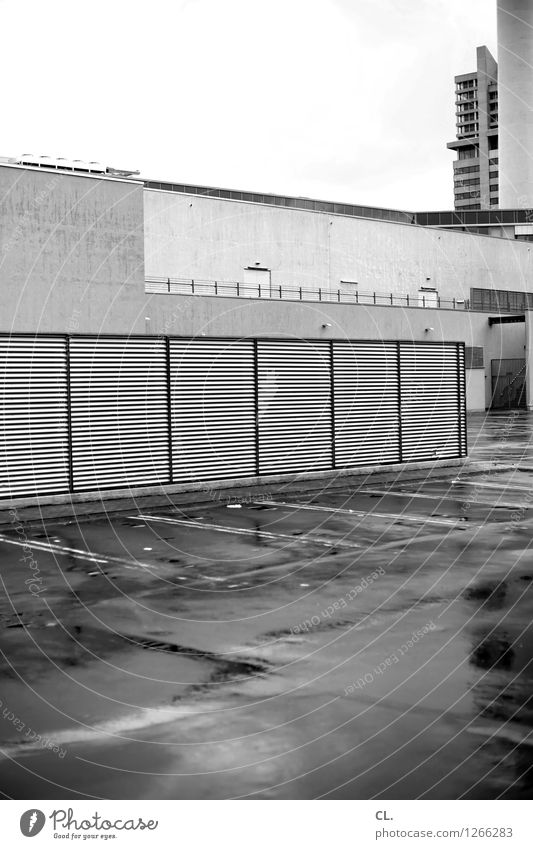 irgendwo schlechtes Wetter Regen Stadt Hochhaus Platz Parkhaus Gebäude Mauer Wand Verkehr Parkplatz trist Schwarzweißfoto Außenaufnahme Menschenleer Tag