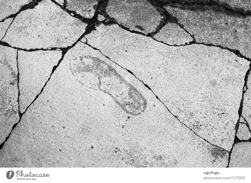A step in the right direction Trainer Schwarzweißfoto foot Druckerzeugnisse pavement concrete cracks track imprint black white ground