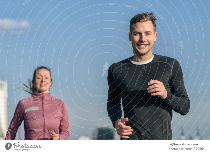 Lächelnder gutaussehender Mann, der mit seiner Frau rüttelt Lifestyle Glück Gesicht Erholung Sport Joggen Erwachsene Freundschaft Paar 2 Mensch 18-30 Jahre