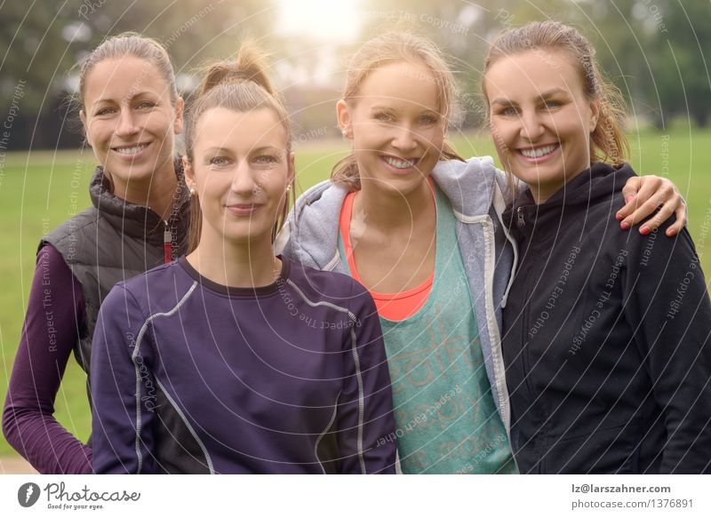 Vier gesunde Frauen nach Sport im Freien Glück Gesicht Erfolg Erwachsene Freundschaft Park Wege & Pfade Fitness Lächeln sportlich dünn 20s Aktion vor der Kamera