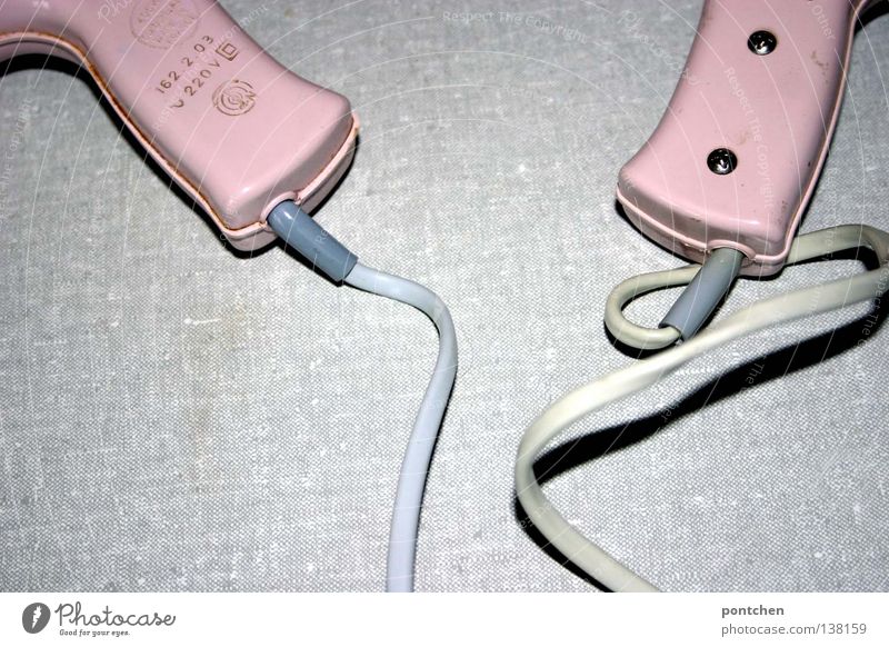 Zwei rosa Föhns des selben Modells liegen nebeneinander. Vintage, Volt, elektrizität. Vergangenheit. Paar Stil schön Haare & Frisuren Bad Energiewirtschaft