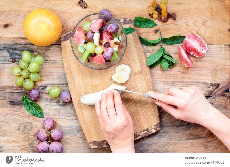 Salat mit frischen Früchten machen Lebensmittel Gemüse Frucht Mittagessen Vegetarische Ernährung Diät Tisch Frau Erwachsene Hand 1 Mensch Holz einfach hell