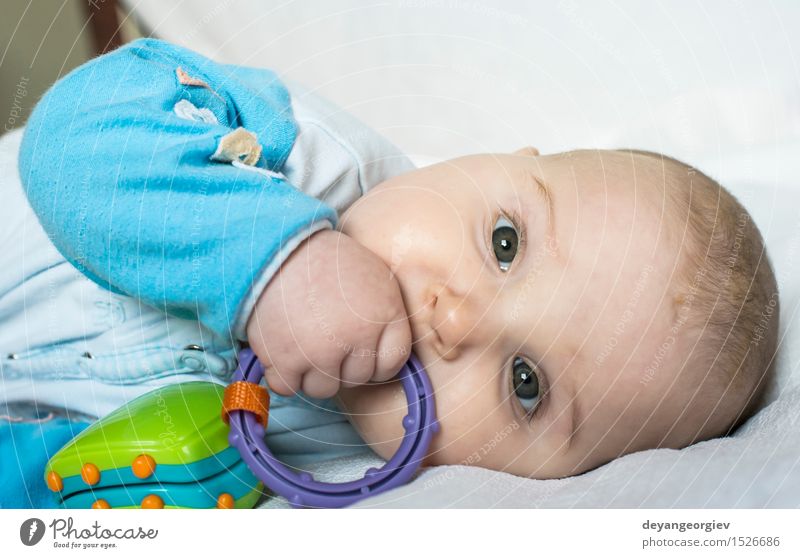 Baby in einem Bett Glück schön Gesicht Leben Spielen Kind Mensch Mädchen Junge Kindheit Hand Spielzeug klein Text Briefe lügen Pflege Kaukasier jung Auge