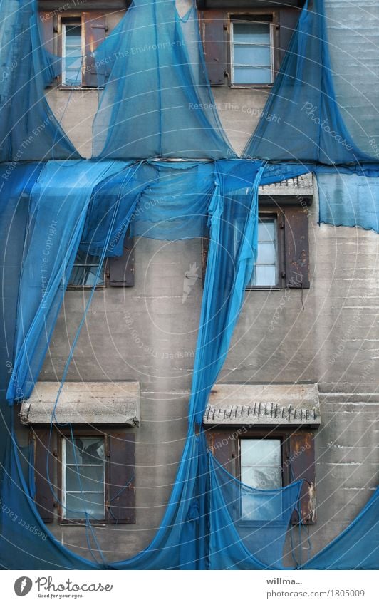 Verhängnisvoll. Zerissenes blaues Gerüstnetz an alter Fabrik Baustelle Gerüstplane Bauwerk Gebäude Architektur Mauer Wand grau Sicherheit Verhüllung Netz