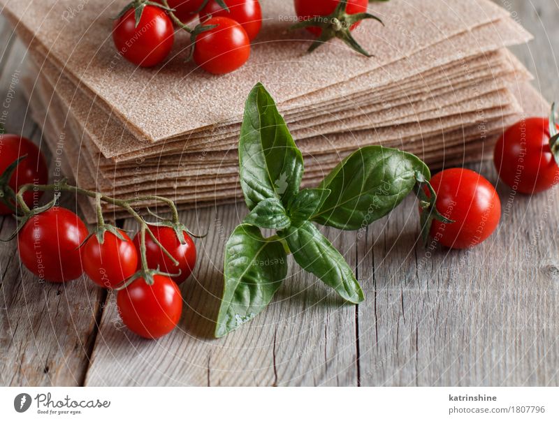 Rohe Lasagne Blätter und Kirschtomaten Gemüse Teigwaren Backwaren Ernährung Italienische Küche Tisch alt braun rot Tradition Essen zubereiten kulinarisch