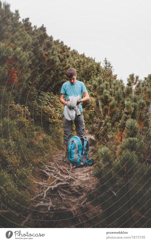Junge, der seine Kleidung zum Rucksack auf Spur verpackt Lifestyle Ferien & Urlaub & Reisen Abenteuer Freiheit Sommer Berge u. Gebirge wandern 1 Mensch Natur