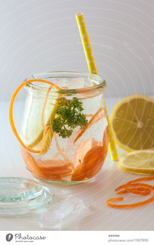 Leckeres Erfrischungsgetränk mit Möhre, Zitrone und Petersilie auf weißem Tisch Gemüse Frucht Bioprodukte Getränk trinken Trinkwasser Eiswürfel Glas Trinkhalm