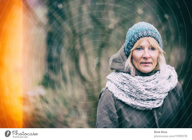 Frau mit Mütze in kalter Jahreszeit feminin Mutter Erwachsene 1 Mensch 45-60 Jahre blond Schal Winter Herbst herbstlich Lichteinfall Frauengesicht Blick