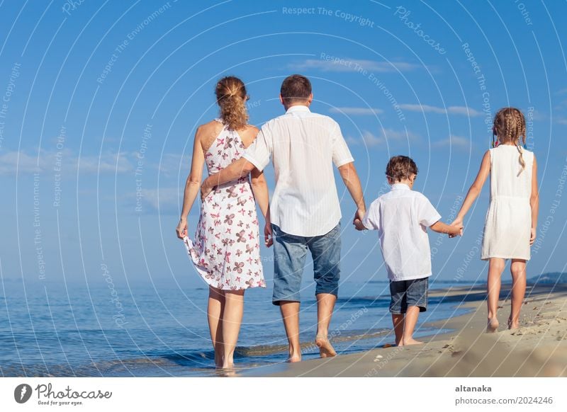 Glückliche Familie zu Fuß am Strand in der Tageszeit. Konzept der freundlichen Familie. Lifestyle Freude Leben Erholung Freizeit & Hobby Spielen