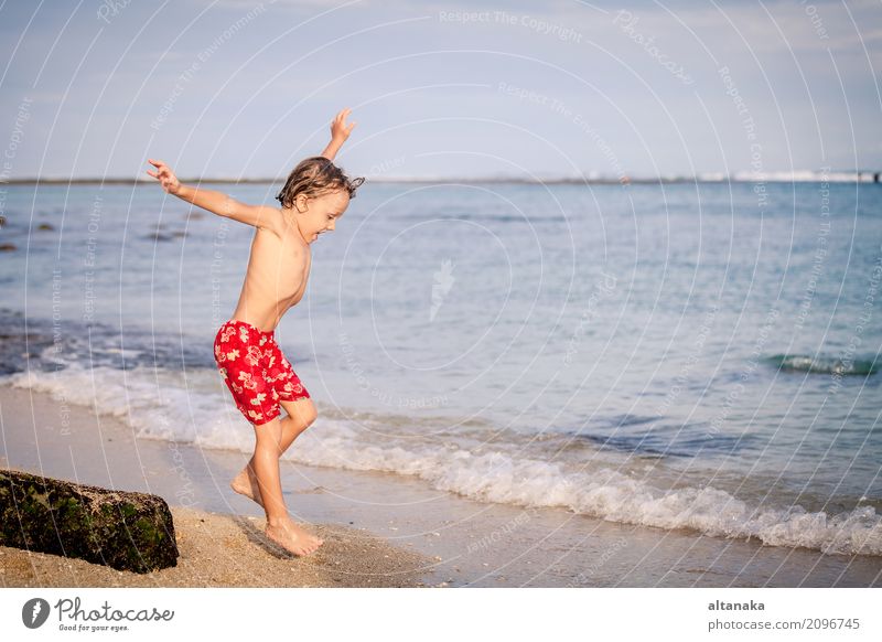 Glücklicher kleiner Junge, der auf den Strand springt Lifestyle Freude Erholung Freizeit & Hobby Spielen Ferien & Urlaub & Reisen Ausflug Abenteuer Freiheit