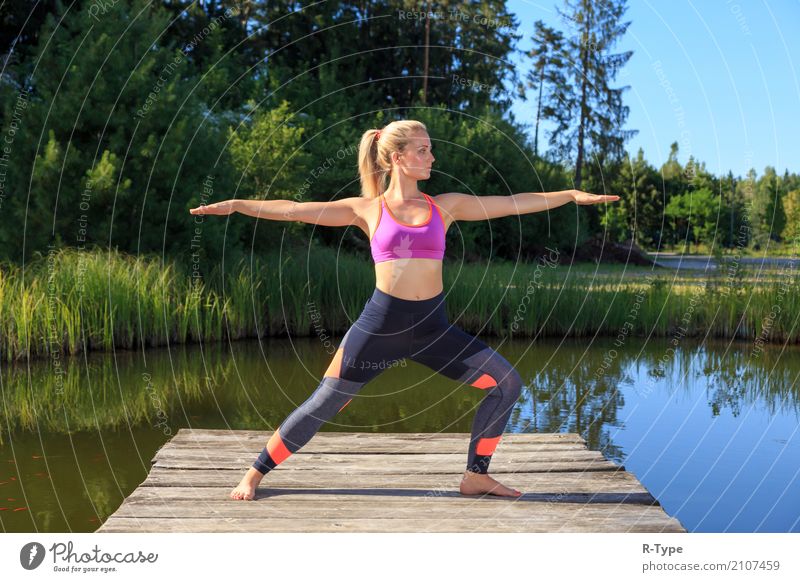 A sporty woman doing yoga and stretching exercises Lifestyle Wellness Sport Yoga Mensch Frau Erwachsene Natur Park Mode blond Fitness Aerobics active athlete