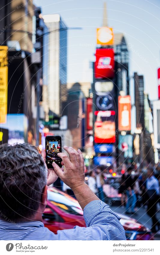 New York Times Square mit Smartphone im Vordergrund in New York Zentralperspektive Starke Tiefenschärfe Sonnenlicht Reflexion & Spiegelung Kontrast Schatten