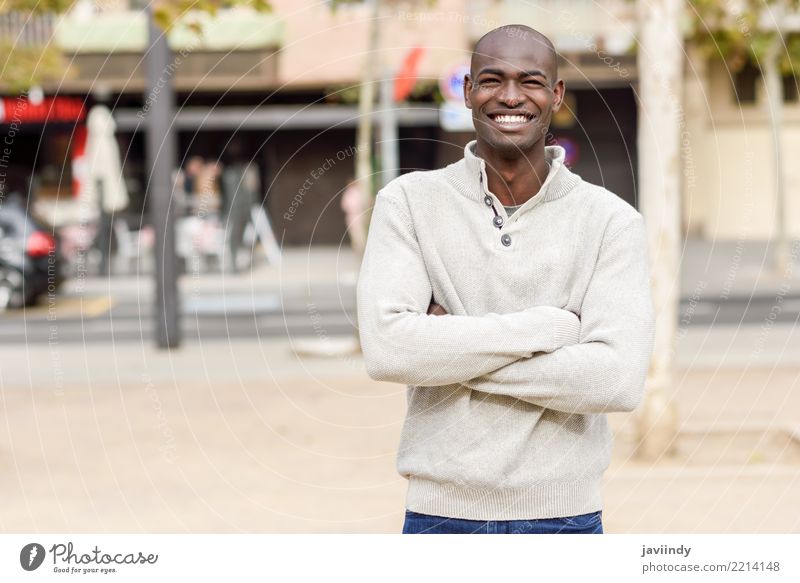 Schwarzer junger Mann mit den Armen kreuzte das Lächeln im städtischen Hintergrund Lifestyle Glück schön Gesicht Mensch Erwachsene 1 18-30 Jahre Jugendliche