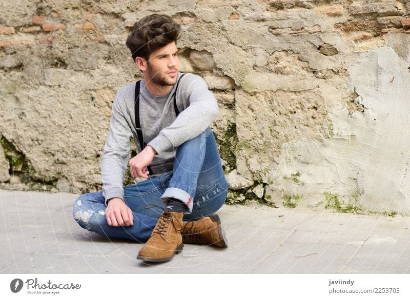 Junger Mann, der auf dem Boden im städtischen Hintergrund sitzt Lifestyle Stil Haare & Frisuren Sommer Mensch maskulin Jugendliche Erwachsene 1 18-30 Jahre