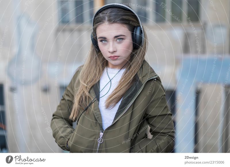 Junges Mädchen mit Kopfhörern auf der Straße stehend Lifestyle Freude Glück schön Leben Erholung Freizeit & Hobby Musik Technik & Technologie Mensch Frau