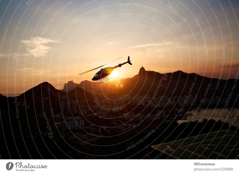 A helicopter flies into the sunset in Rio de janeiro Landschaft Schönes Wetter Berge u. Gebirge Rio de Janeiro Brasilien Hauptstadt Hafenstadt Skyline