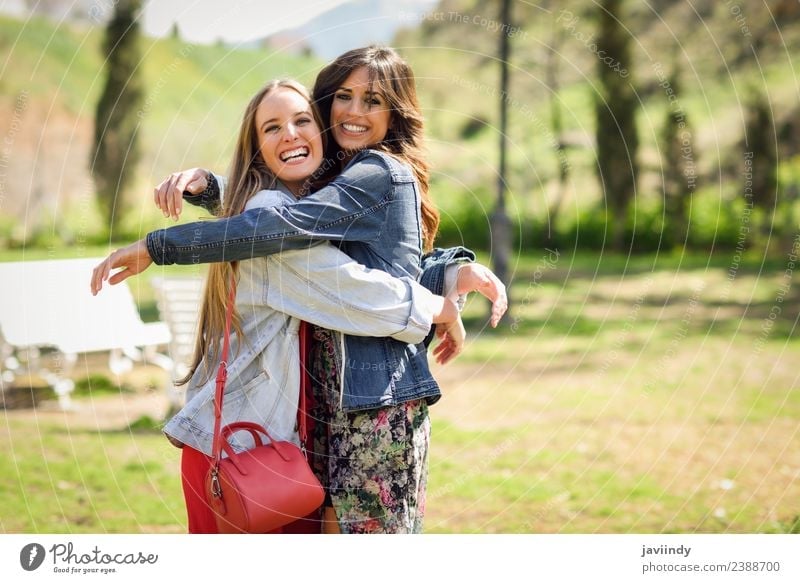 Zwei glückliche Mädchen, die sich im Stadtpark umarmen. Lifestyle Stil Freude Glück schön Mensch feminin Junge Frau Jugendliche Erwachsene Freundschaft 2