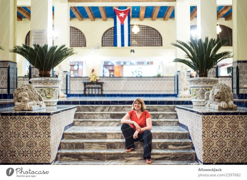 junge Frau sitzt vor Hotel in Havanna Kuba Insel Sozialismus Ferien & Urlaub & Reisen Reisefotografie Ausflug Sightseeing Fahne Patriotismus Fernweh Haus Abend