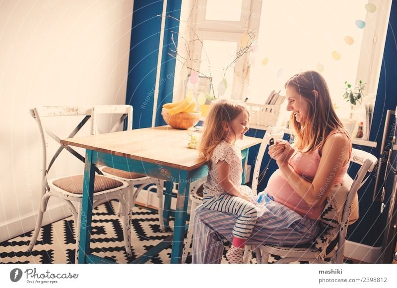glückliches Kleinkind-Mädchen spielt mit schwangerer Mutter Frühstück Tee Küche Kind Baby Eltern Erwachsene Schwester Familie & Verwandtschaft Freundschaft