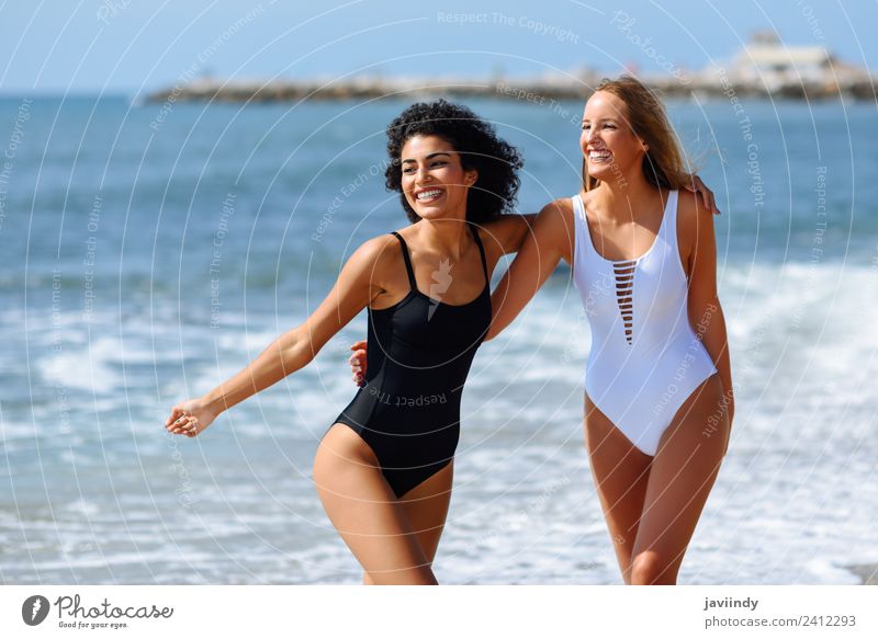 Zwei junge Frauen in Badebekleidung an einem tropischen Strand. Lifestyle Freude Glück schön Haare & Frisuren Freizeit & Hobby Ferien & Urlaub & Reisen