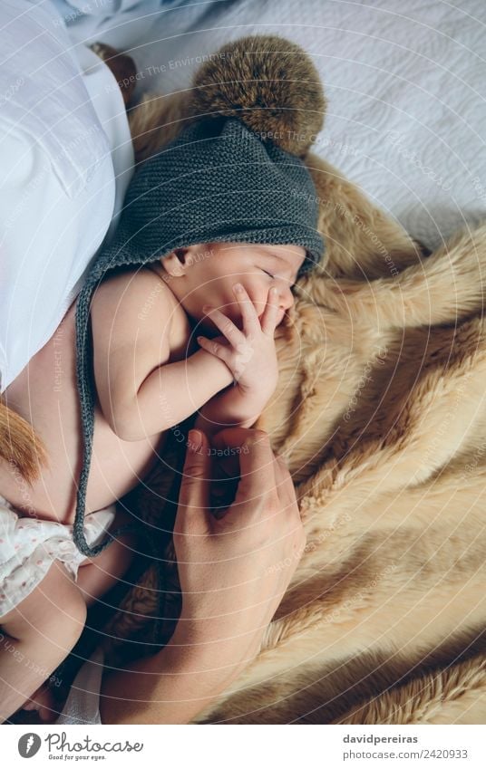 Neugeborenes Baby Mädchen schlafend auf dem Bett liegend neben der Hand der Mutter schön Windstille Schlafzimmer Kind Mensch Frau Erwachsene