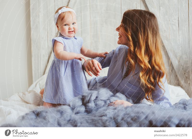 glückliche Mutter und 9 Monate altes Baby im passenden Pyjama Lifestyle Freude Spielen Schlafzimmer Eltern Erwachsene Familie & Verwandtschaft Kindheit Hand