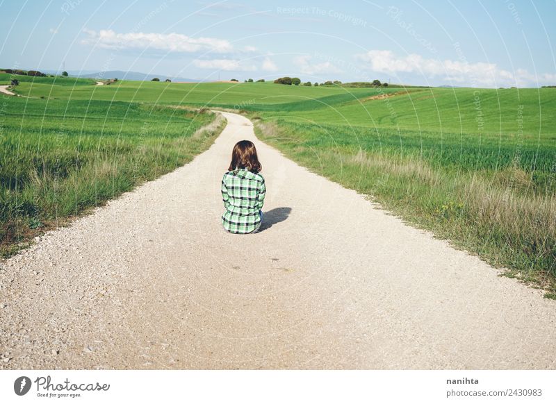 Junge Frau, die allein auf einem ländlichen Weg sitzt. Lifestyle Stil Design harmonisch Erholung Abenteuer Ferne Freiheit Mensch feminin Jugendliche 1