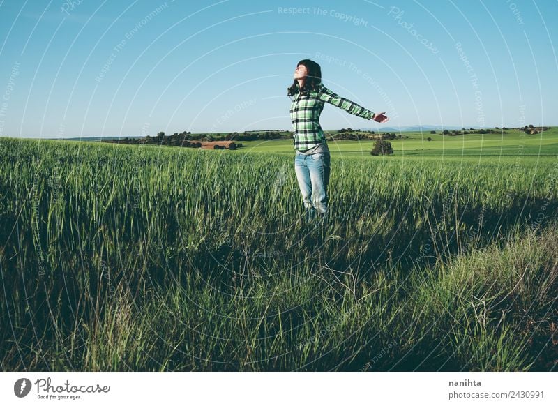 Junge Frau genießt den Tag auf einem Feld mit Grünflächen. Lifestyle Stil Freude Gesundheit Wellness Leben harmonisch Wohlgefühl Sinnesorgane