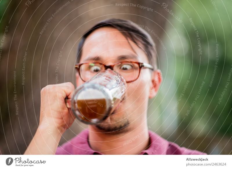 Portrait von einem jungen Mann mit Bierglas in der Hand Porträt 1 Mensch Junger Mann Oberkörper Blick unaufmerksam Wetttrinken Bierkrug Trinkgefäß Alkohol