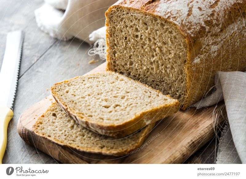 Rustikales Brot auf Holztisch Müsli Lebensmittel Gesunde Ernährung Foodfotografie Mehl gebastelt Frühstück braun Abendessen Essen Bäckerei Toastbrot Gesundheit