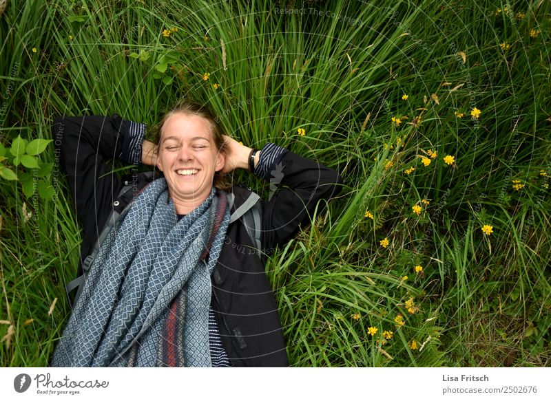 Lachend im Gras liegend, Augen geschlossen. Ferien & Urlaub & Reisen Tourismus Frau Erwachsene 1 Mensch 18-30 Jahre Jugendliche Natur Blume Wiese Schal Zopf