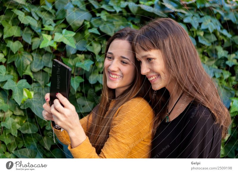 Nette Schwestern mit blauen Augen Lifestyle Freude Glück schön Leben Spielen Telefon Handy PDA Technik & Technologie Internet Frau Erwachsene Freundschaft