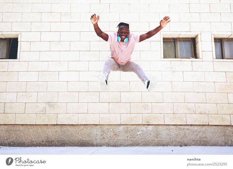 Glücklicher junger Mann, der an einem urbanen Ort springt. Lifestyle Stil Freude Gesundheit sportlich Wellness Leben Wohlgefühl Freizeit & Hobby Freiheit