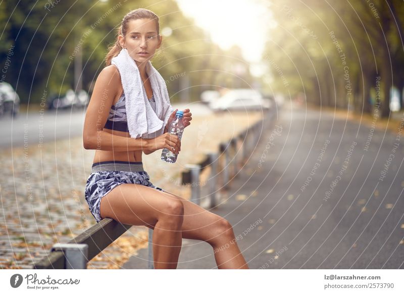 Glückliche Frau, die eine Pause vom Joggen macht. trinken Lifestyle Sommer Sport Erwachsene 1 Mensch 18-30 Jahre Jugendliche Wärme Straße Fitness rennen