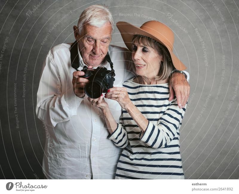 Porträt von glücklichen Senior Paar mit Digitalkamera auf grauem Hintergrund Lifestyle Freude Ferien & Urlaub & Reisen Ausflug Kreuzfahrt Ruhestand Fotokamera