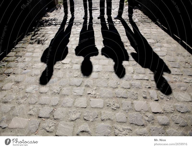 Männerschatten maskulin 4 Mensch stehen Pflastersteine schwarz Schattenspiel Körperhaltung abstrakt Menschengruppe Kontrast Silhouette Licht grau Lichteffekt