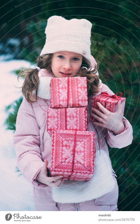 fröhliches Kind Mädchen spielt im Freien mit Weihnachtsgeschenken Lifestyle Freude Glück Spielen Ferien & Urlaub & Reisen Winter Schnee Feste & Feiern