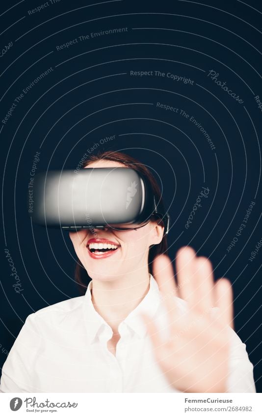 Lächelnde Lachende Frau mit VR Brille und weißer Bluse vor neutralem dunklen Hintergrund Lifestyle Freizeit & Hobby Technik & Technologie