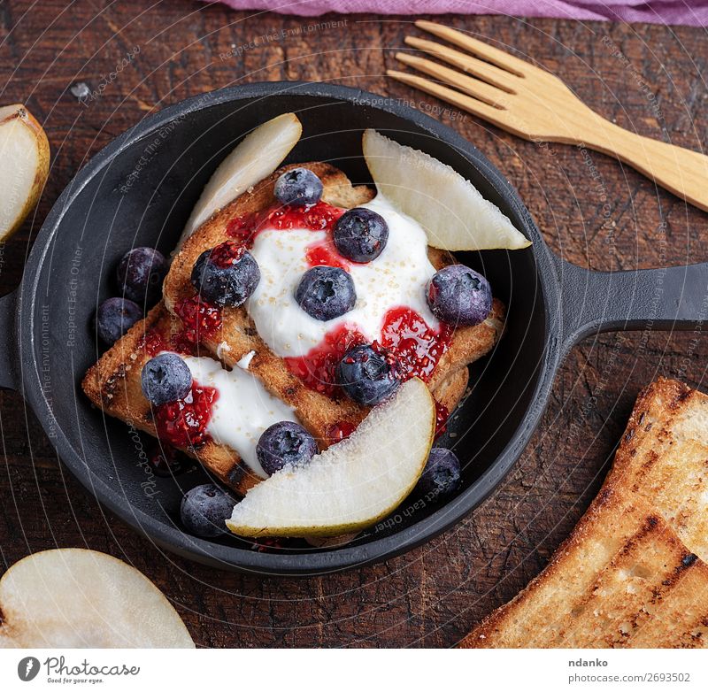 Französischer Toast mit Beeren, Sirup und saurer Sahne Frucht Brot Dessert Ernährung Frühstück Mittagessen Pfanne Gabel Tisch Holz frisch lecker weiß
