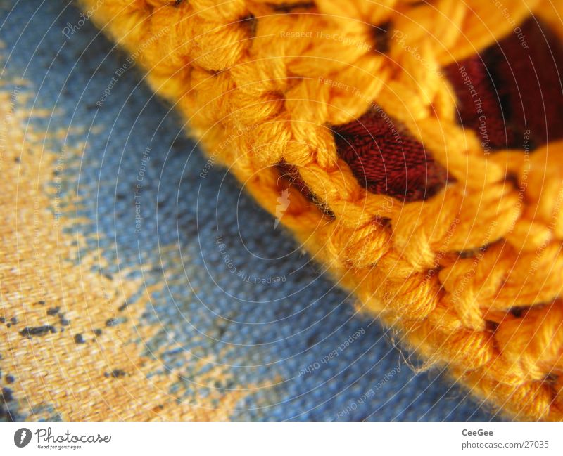 Kissen Faser gelb Stoff Wolle gewebt weich kuschlig Häusliches Leben orange blau Makroaufnahme Nahaufnahme