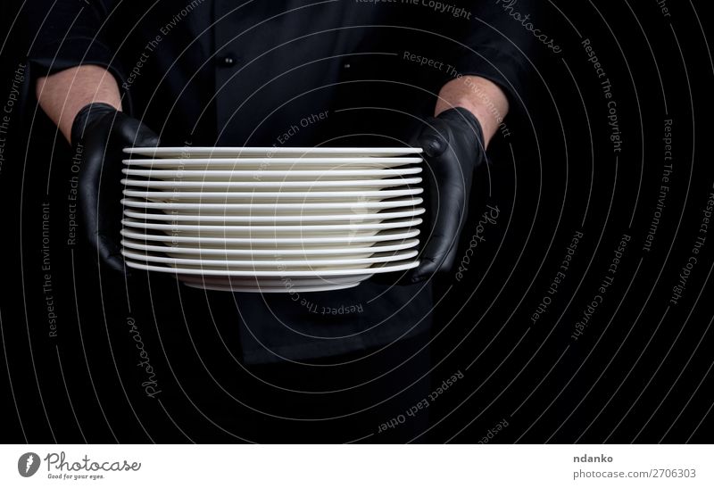 ein Stapel runder weißer leerer Teller Küche Restaurant Beruf Mensch Mann Erwachsene Hand Handschuhe stehen dunkel schwarz Kaukasier Küchenchef Koch