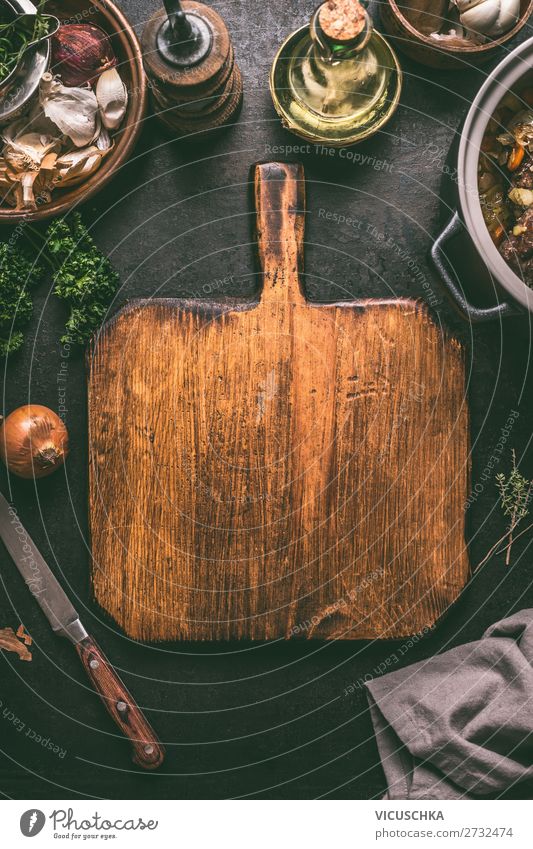 Schneidebrett mit Messer auf dunklem Küchentisch Lebensmittel Ernährung Geschirr Stil Design Tisch retro Hintergrundbild altehrwürdig Essen zubereiten Speise