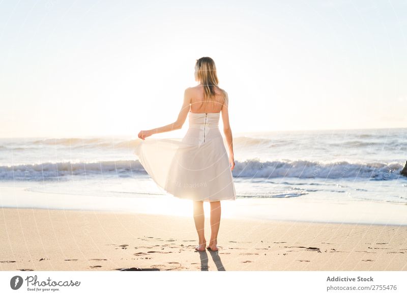 Wunderschöne zärtliche Braut im Sonnenlicht Frau Fröhlichkeit Strand Porträt heiter Seeküste Kleid verliebt Meereslandschaft blond Engagement Ausdruck elegant