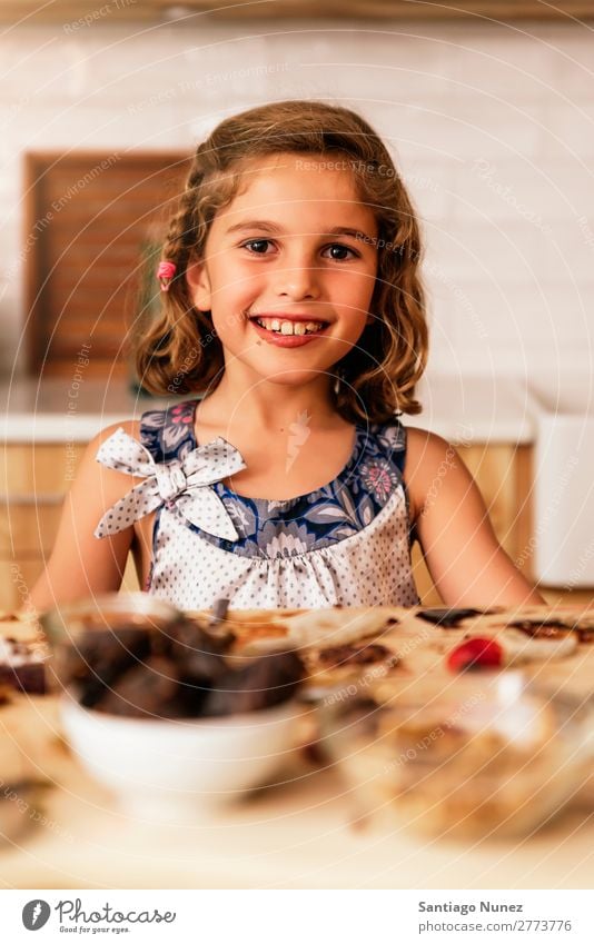 Porträt eines kleinen Mädchens beim Backen von Keksen. Kind Ernährung Fressen Verkostung Essen genießend Appetit & Hunger Lächeln lachen Mittagessen Baby