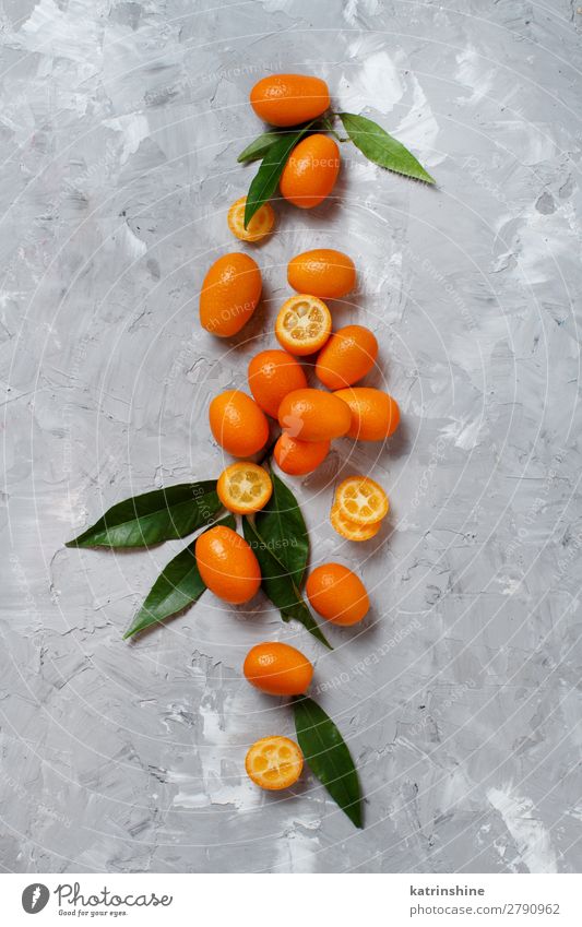 Kumquat-Früchte auf grauem Hintergrund Frucht Dessert Ernährung Vegetarische Ernährung Diät exotisch Menschengruppe Blatt frisch natürlich oben saftig gelb