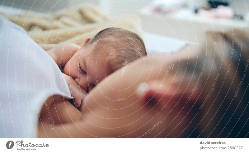 Neugeborenes liegt auf dem Bett mit ihrer Mutter. Lifestyle schön Kind Mensch Baby Frau Erwachsene Familie & Verwandtschaft Liebe schlafen Umarmen authentisch