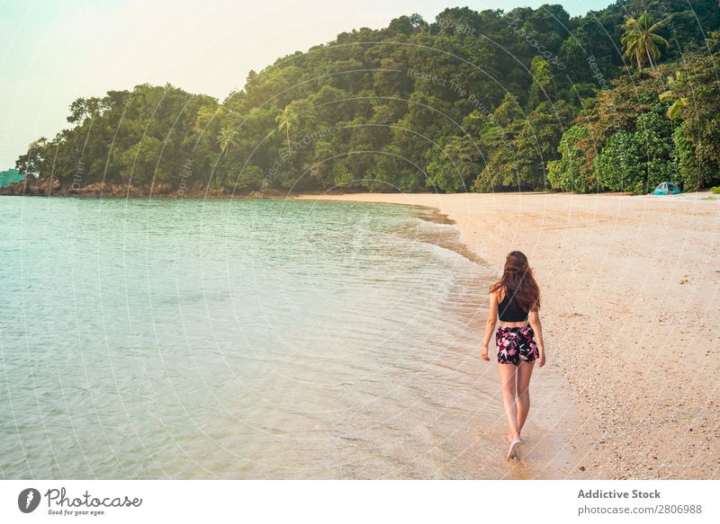 Frau, die am Sandufer in der Nähe des Wassers spazieren geht. Strand Meer laufen Jamaika Wald Küste tropisch exotisch Sommer Spielen dünn Dame Handfläche