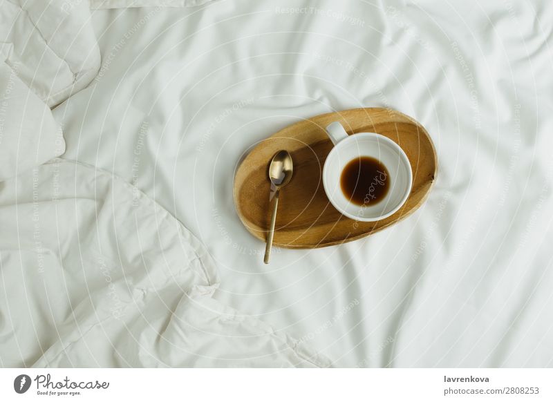 Tasse Kaffee und Löffel auf Holztablett im Bett auf weißen Laken Tablett Schlafzimmer Espresso Gesundheit Gesunde Ernährung Feiertag Tee Getränk schwarz heiß