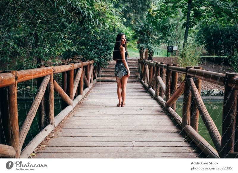 Junge Frau auf Holzbrücke hübsch Jugendliche schön Brücke stehen heiter Lächeln brünett attraktiv Mensch Beautyfotografie Erwachsene Stil niedlich Lifestyle