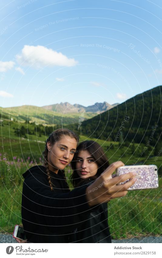 Frauen nehmen Selfie auf der Wiese mit. PDA Sommer Jugendliche Porträt Gras Freude Mobile Natur Lifestyle hübsch Körperhaltung Apparatur Gerät Gesicht Model